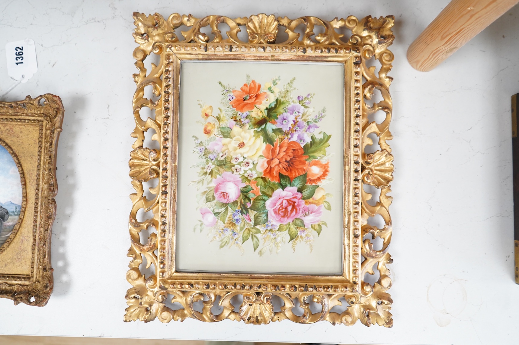 A late 19th century English flower painted porcelain plaque in ornate Florentine giltwood frame, 18.5cm wide x 24cm high
